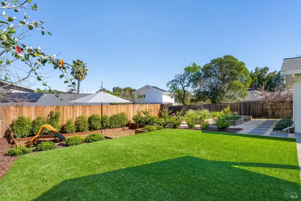a view of a backyard with sitting area