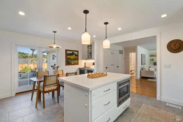 a open kitchen with a table and chairs in it