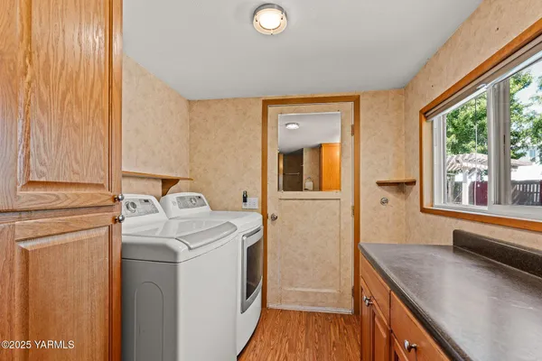 a bathroom with a granite countertop sink a mirror and a shower