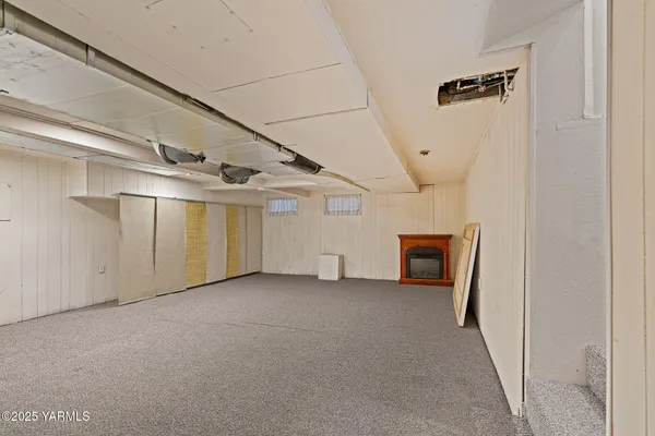 a utility room with a bed and a window