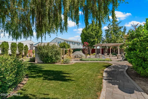 a backyard of a house with table and chairs