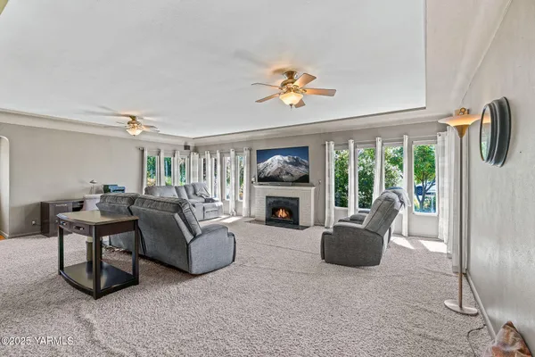 a living room with furniture a fireplace and a flat screen tv
