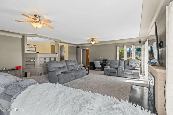 a bedroom with furniture and a large window