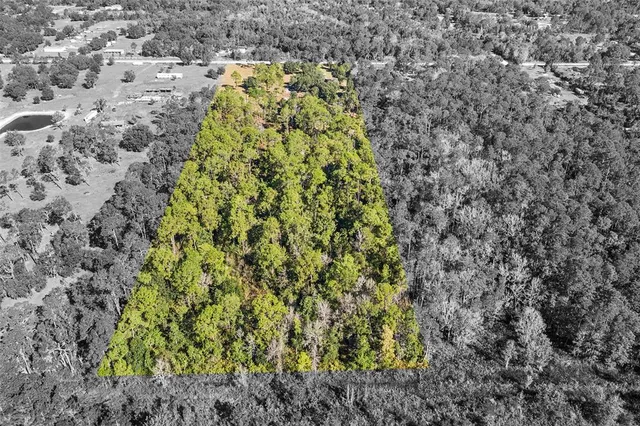 a view of a city with green field