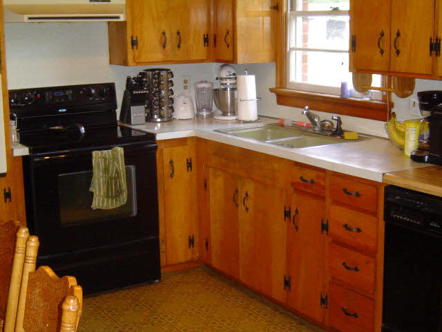 7464 Spring Creek Road Bridgewater, VA 22812 - Photo 6 of 9 a kitchen with granite countertop a refrigerator a sink and wooden cabinets