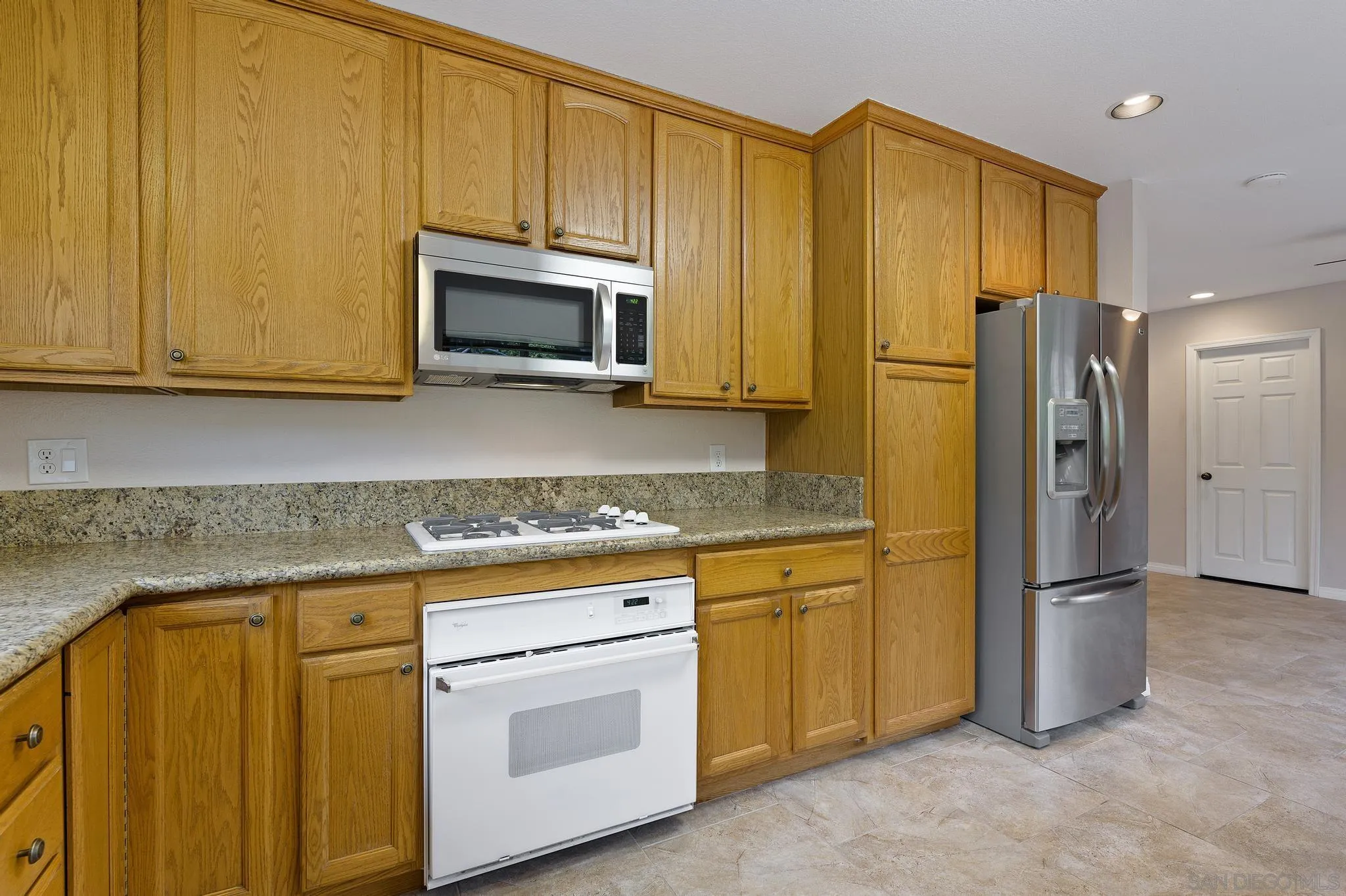 12443 McFeron Road Poway, CA 92064 - Photo 14 of 37 a kitchen with stainless steel appliances granite countertop a refrigerator stove microwave and sink
