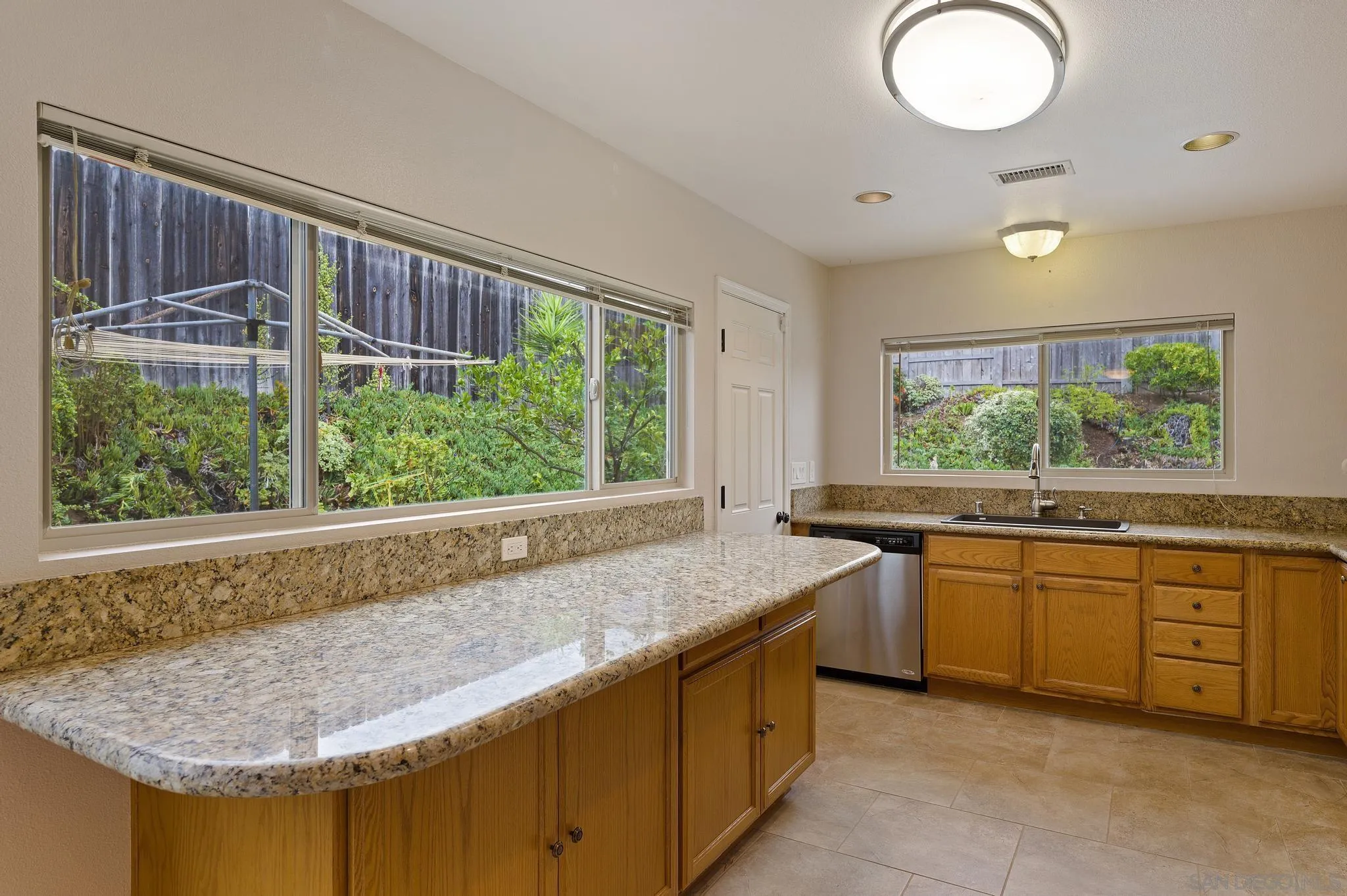 12443 McFeron Road Poway, CA 92064 - Photo 16 of 37 a kitchen with a sink and a large window
