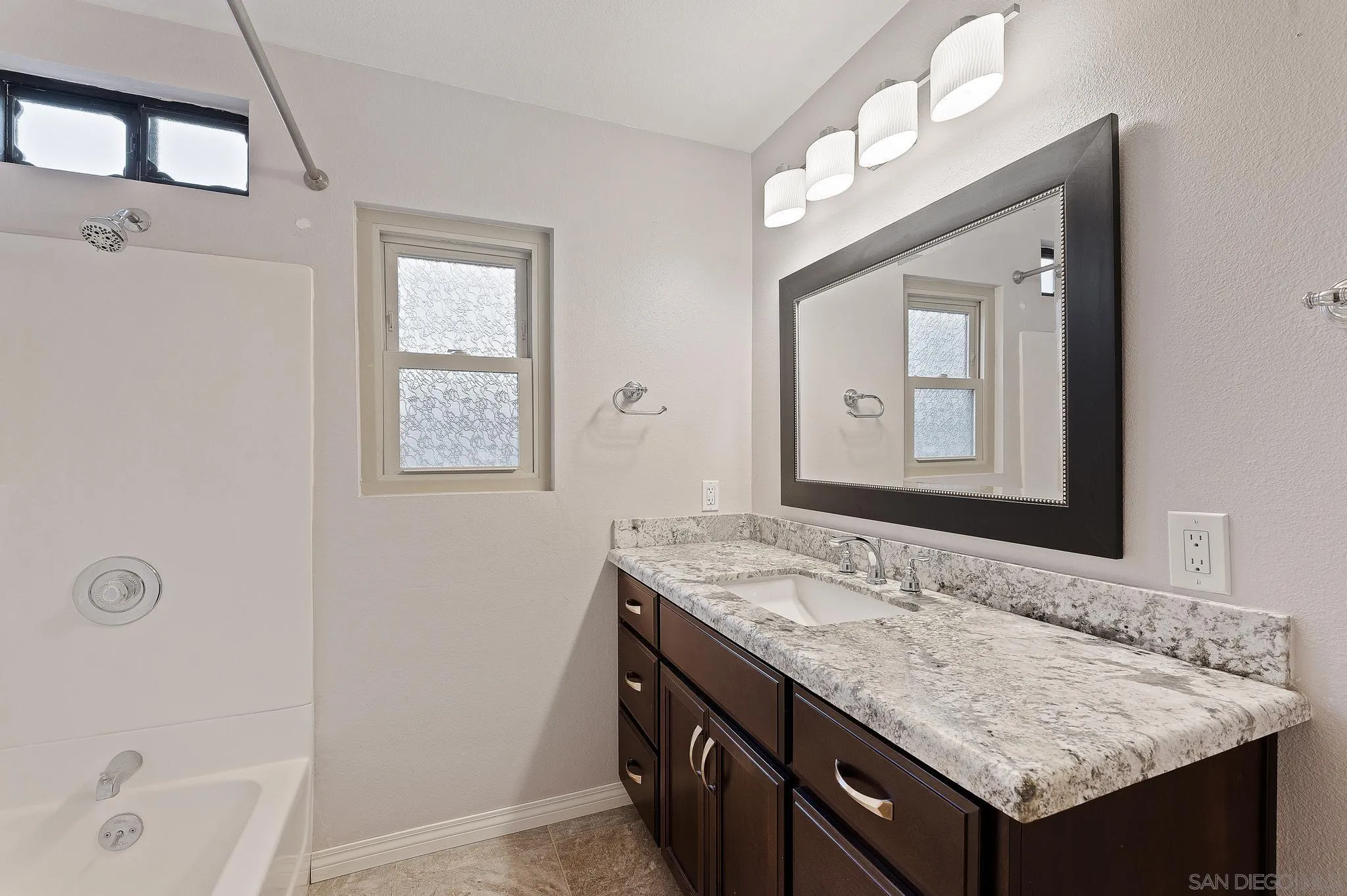 12443 McFeron Road Poway, CA 92064 - Photo 27 of 37 a bathroom with a granite countertop sink and a mirror