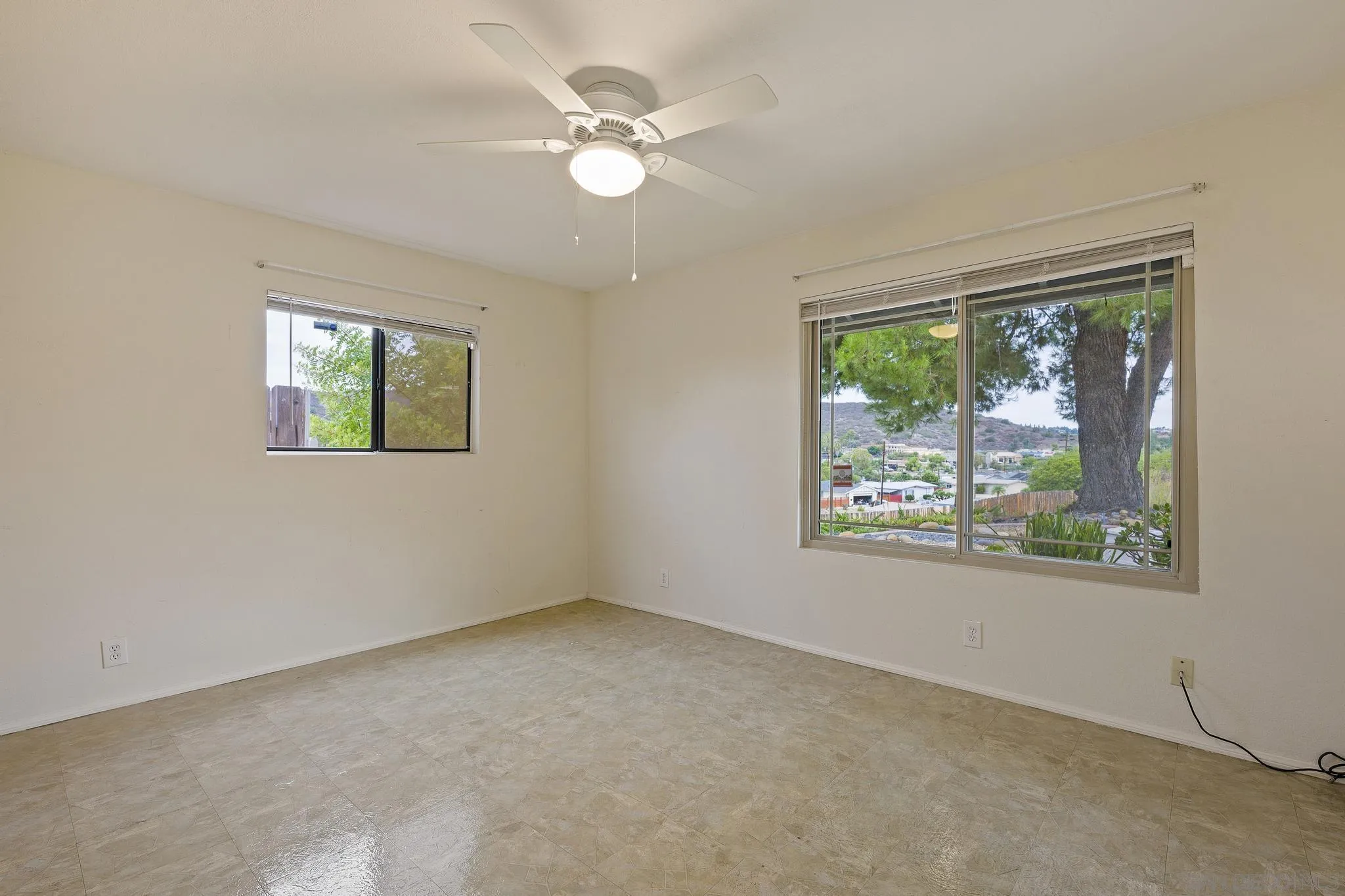 12443 McFeron Road Poway, CA 92064 - Photo 28 of 37 an empty room with windows and fan