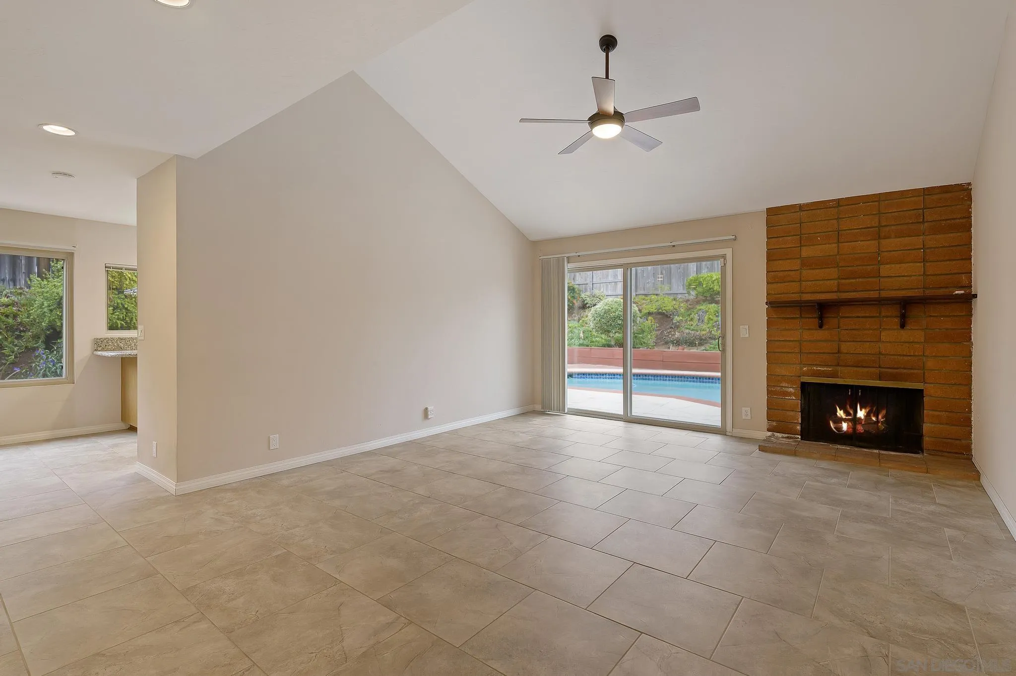 12443 McFeron Road Poway, CA 92064 - Photo 9 of 37 an empty room with windows and fireplace