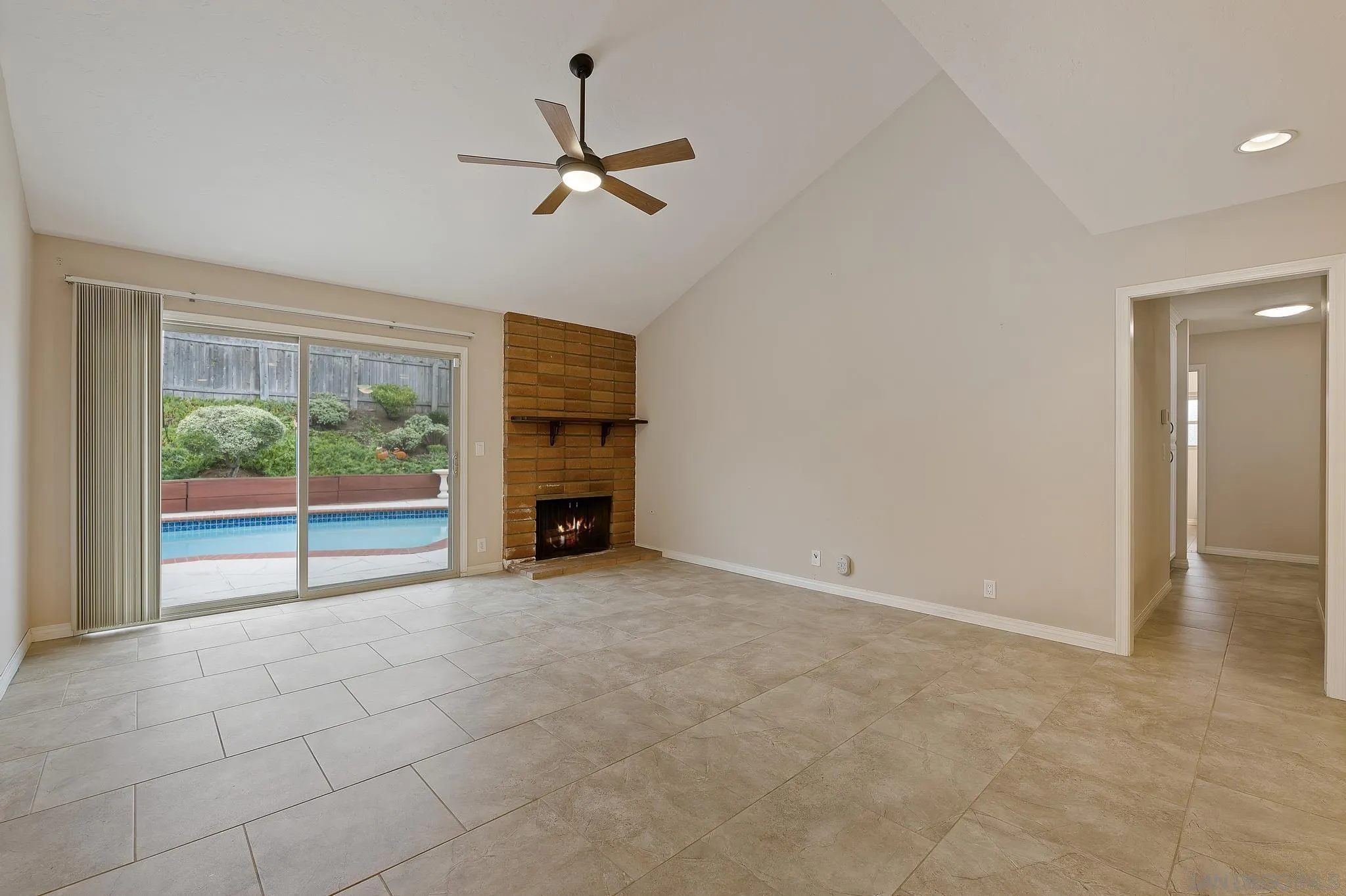 12443 McFeron Road Poway, CA 92064 - Photo 10 of 37 a view of empty room with fireplace and fan