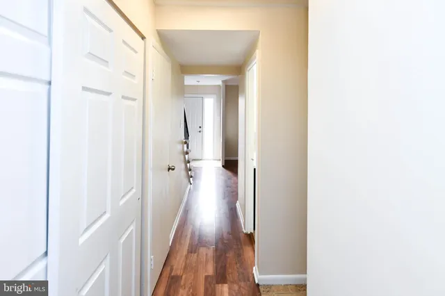 a view of a hallway with wooden floor