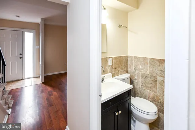 a bathroom with a granite countertop toilet sink and mirror