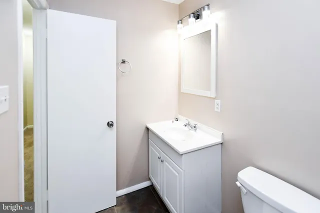 a bathroom with a toilet sink and mirror