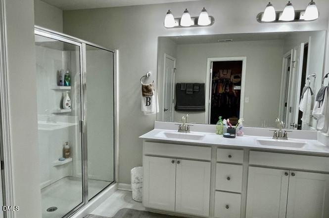 1807 Wrenn Road Durham, NC 27703 - Photo 22 of 43 a bathroom with a double vanity sink mirror and shower