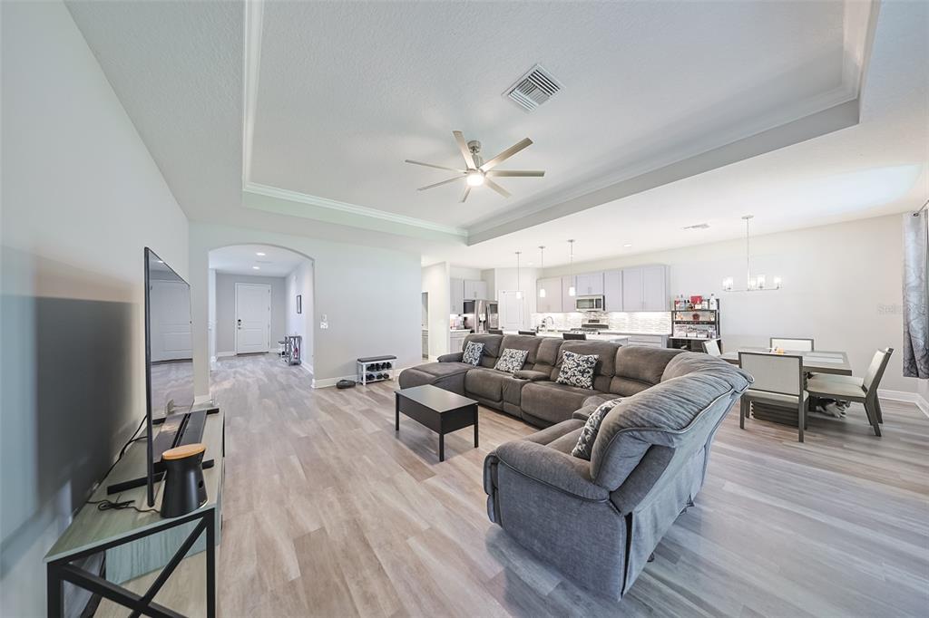 130 Azul Drive Seffner, FL 33584 - Photo 12 of 47 a living room with furniture a ceiling fan and a flat screen tv
