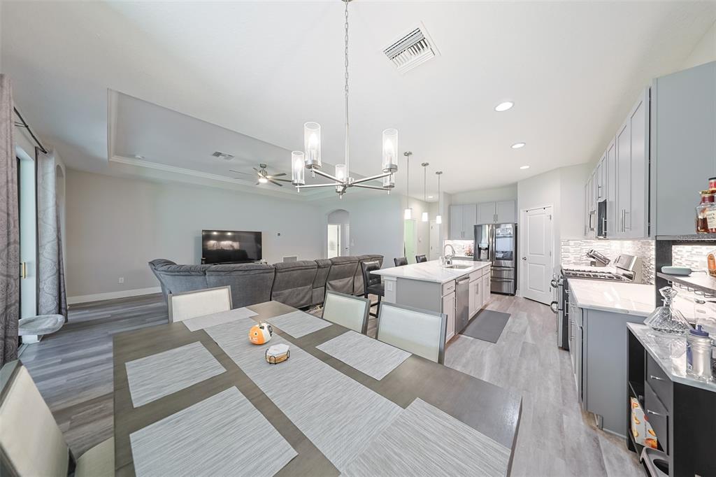 130 Azul Drive Seffner, FL 33584 - Photo 13 of 47 a living room with lots of furniture hardwood floor and a kitchen view