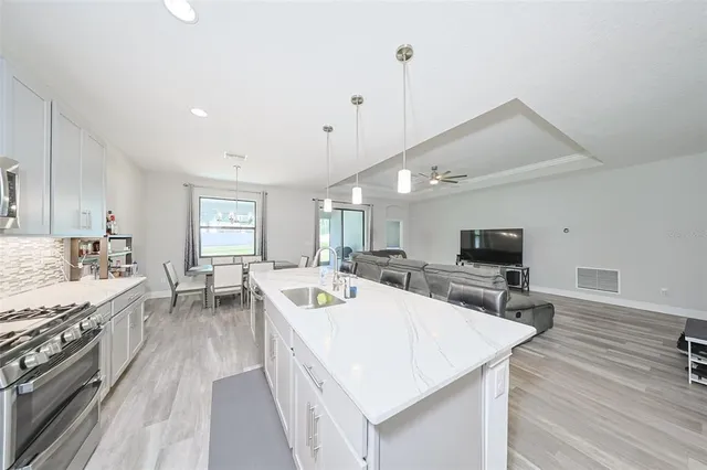 a large kitchen with a table and chairs in it