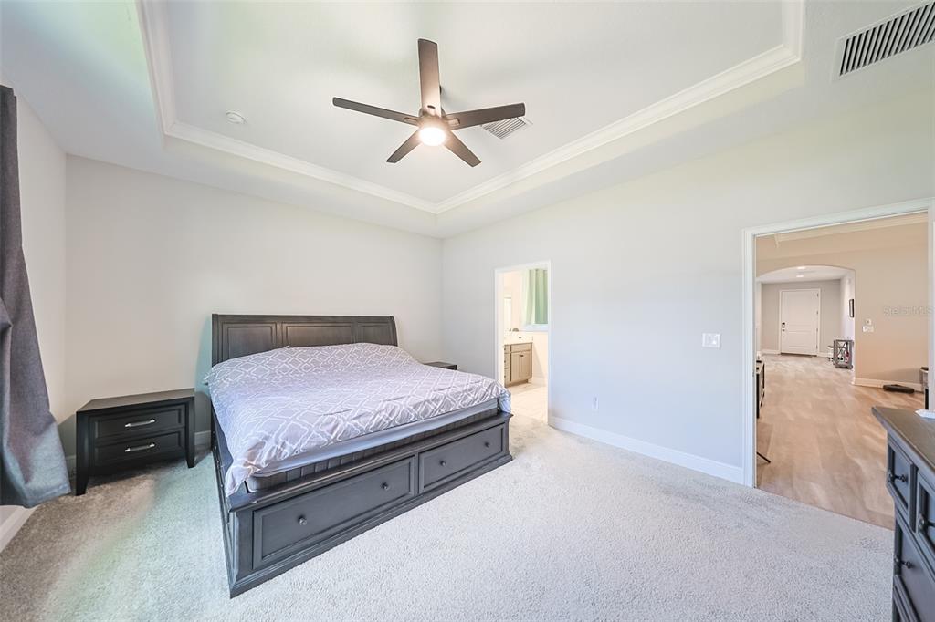 130 Azul Drive Seffner, FL 33584 - Photo 20 of 47 a bedroom with a bed and a chandelier