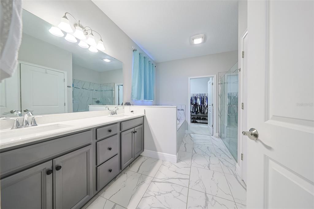 130 Azul Drive Seffner, FL 33584 - Photo 22 of 47 a spacious bathroom with a double vanity sink a mirror and shower
