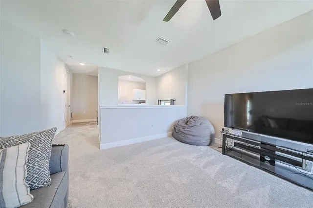 a bedroom with furniture and a flat screen tv