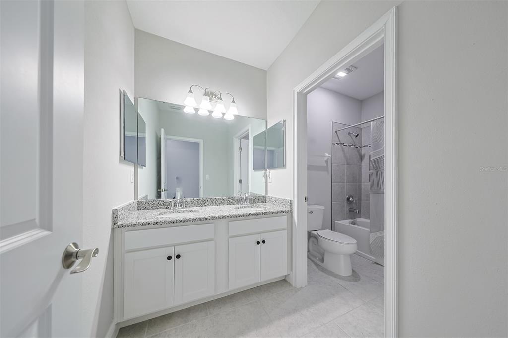 130 Azul Drive Seffner, FL 33584 - Photo 29 of 47 a spacious bathroom with a granite countertop sink a toilet and a mirror