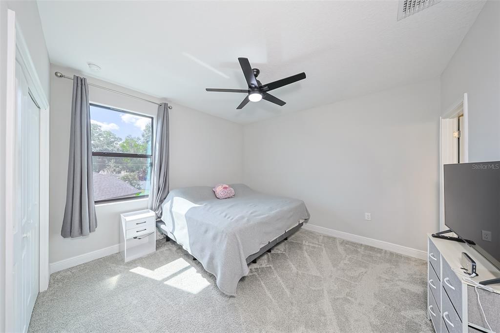 130 Azul Drive Seffner, FL 33584 - Photo 31 of 47 a bedroom with a bed and a flat screen tv