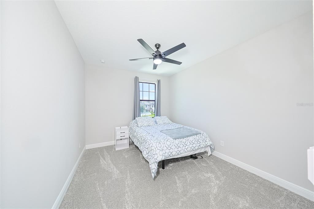 130 Azul Drive Seffner, FL 33584 - Photo 35 of 47 a room with a bed and a chandelier