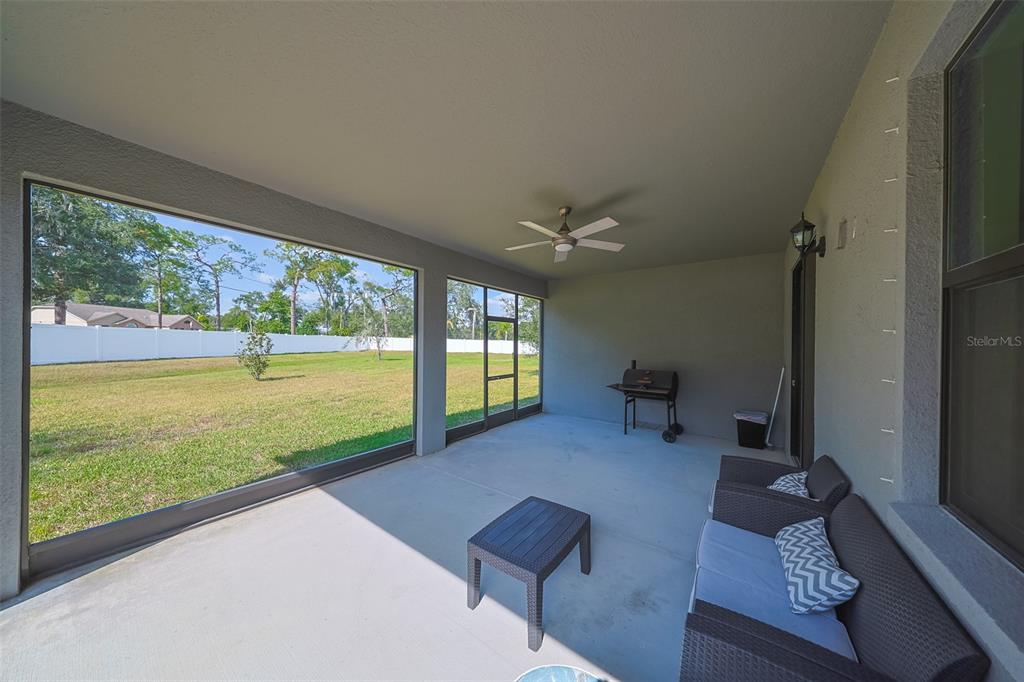 130 Azul Drive Seffner, FL 33584 - Photo 41 of 47 a living room with furniture floor to ceiling window and an outdoor view
