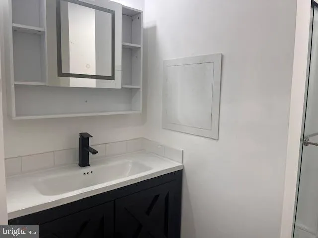 a bathroom with a glass shower door