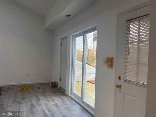 a view of room with hardwood floor and window