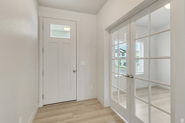 4572 Flower Point Eagle Mountain, UT 84005 - Photo 9 of 62 Entryway featuring a white paneled door with glass insert, wood-finish flooring, and white interior walls
