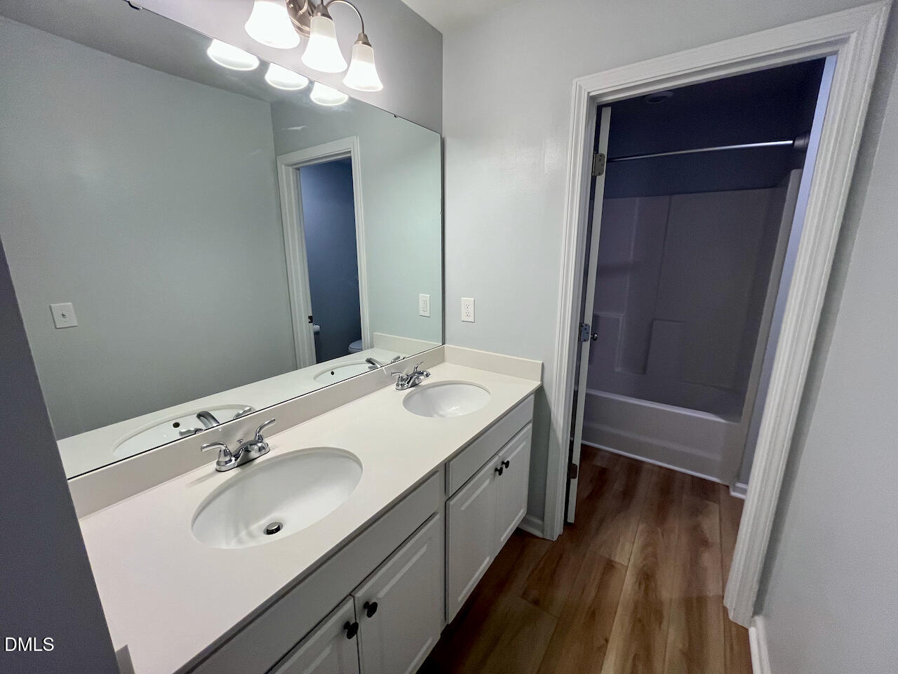 924 Peninsula Place Knightdale, NC 27545 - Photo 12 of 22 a bathroom with a double vanity sink and a mirror