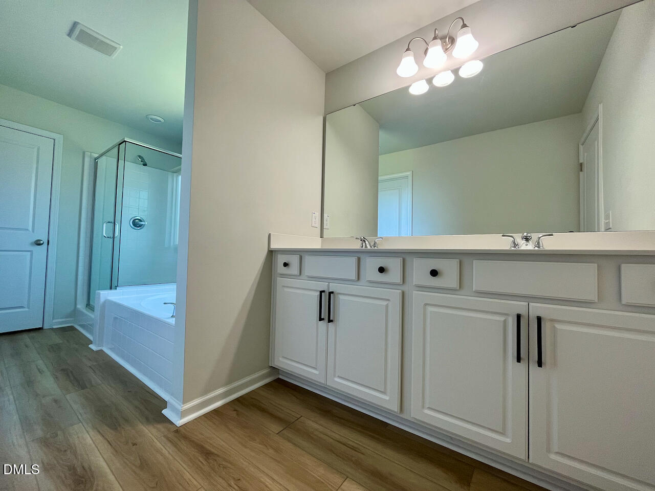 924 Peninsula Place Knightdale, NC 27545 - Photo 15 of 22 a view of a hallway with entryway wooden floor and cabinet
