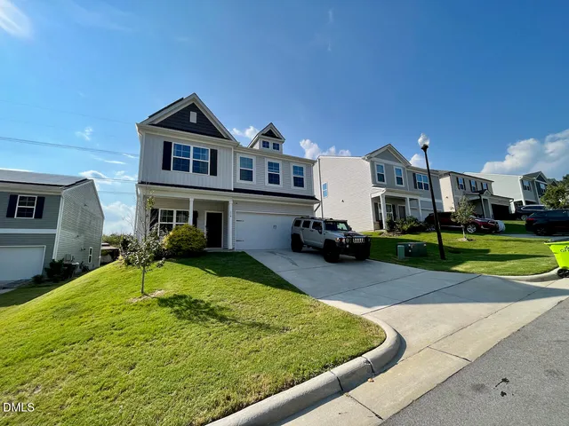 a front view of a house with a yard table and chairs