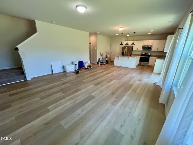 a view of empty room with wooden floor