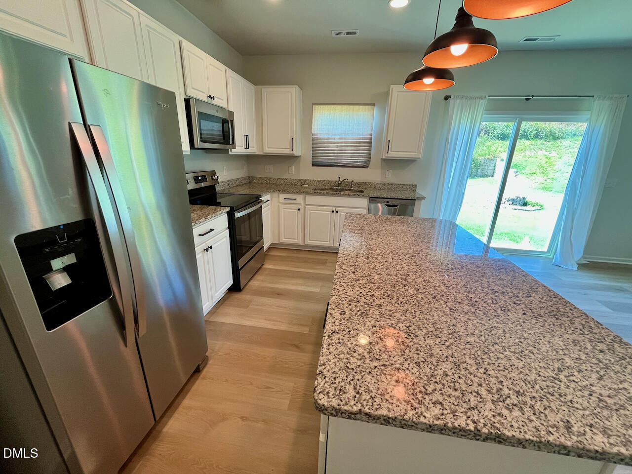 924 Peninsula Place Knightdale, NC 27545 - Photo 9 of 22 a kitchen with stainless steel appliances granite countertop a refrigerator and a sink