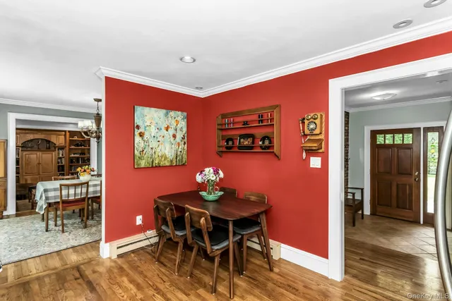 a dining room with furniture and wooden floor
