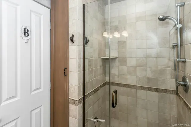 a bathroom with a glass shower door