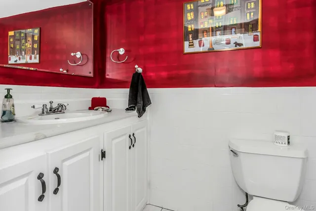 a bathroom with a toilet sink and mirror