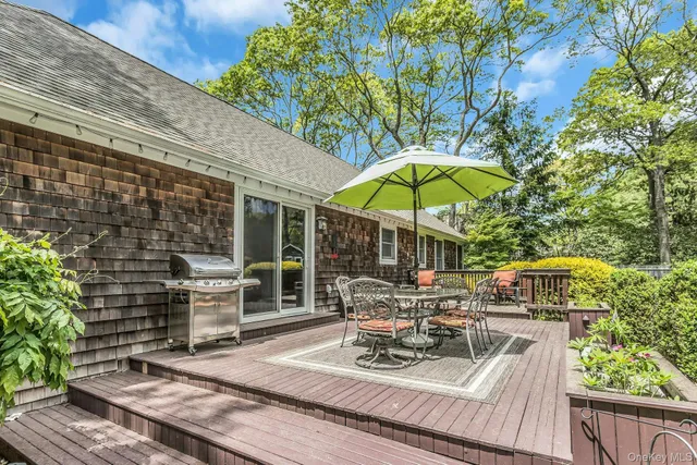 a view of a chair and tables in the patio