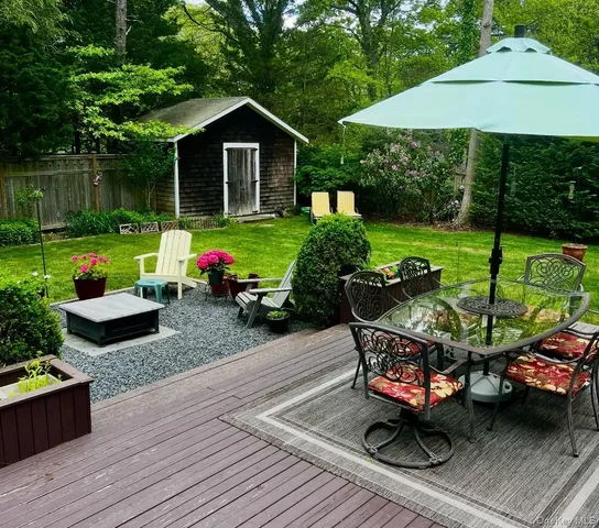 a view of an house with backyard sitting area and garden