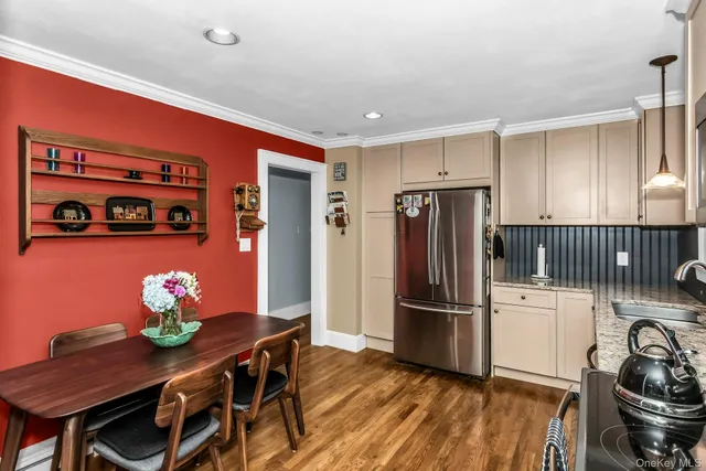 a kitchen with stainless steel appliances granite countertop a refrigerator and a stove top oven