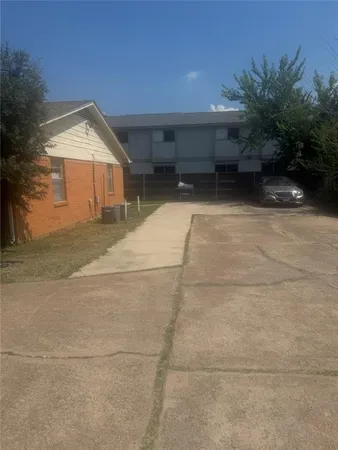 a backyard of a house with plants and trees