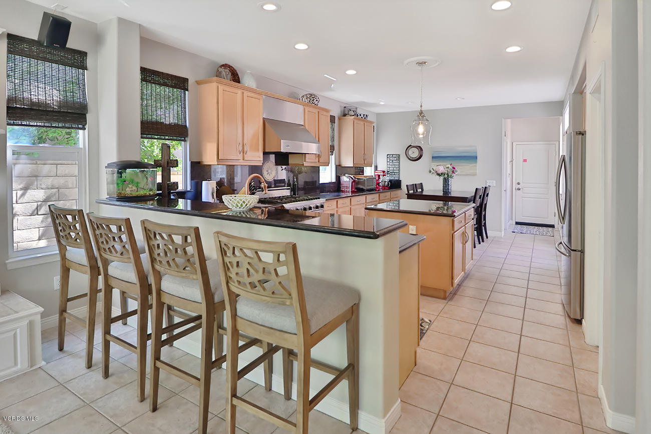 143 Brooks Road Simi Valley, CA 93065 - Photo 11 of 42 a kitchen with stainless steel appliances granite countertop table chairs sink and window