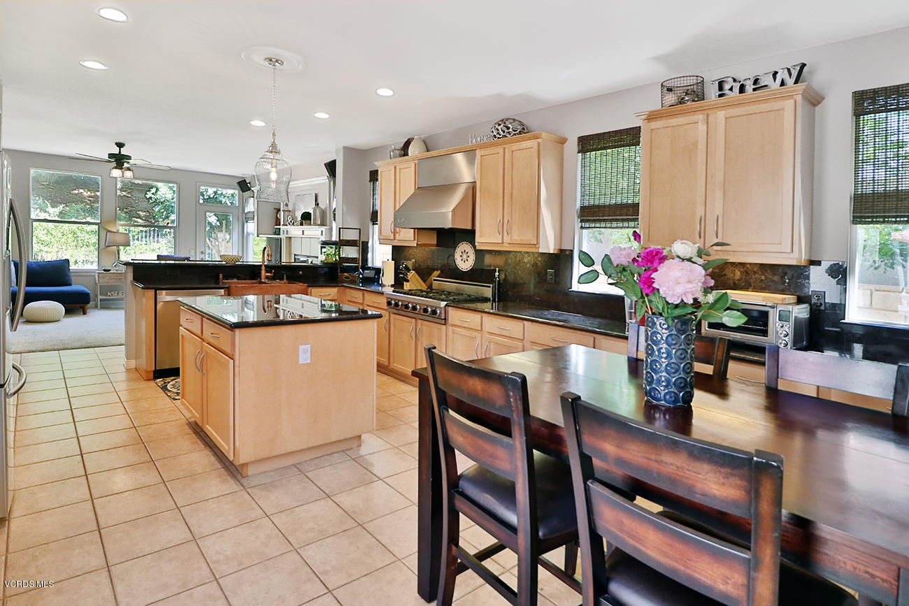 143 Brooks Road Simi Valley, CA 93065 - Photo 15 of 42 a kitchen with stainless steel appliances kitchen island granite countertop a stove a sink and a dining table