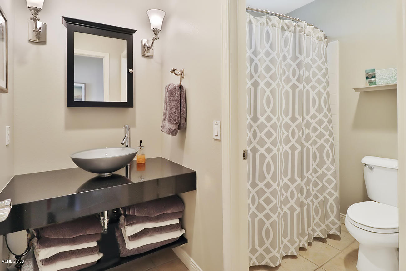 143 Brooks Road Simi Valley, CA 93065 - Photo 19 of 42 a bathroom with a toilet a sink and a mirror