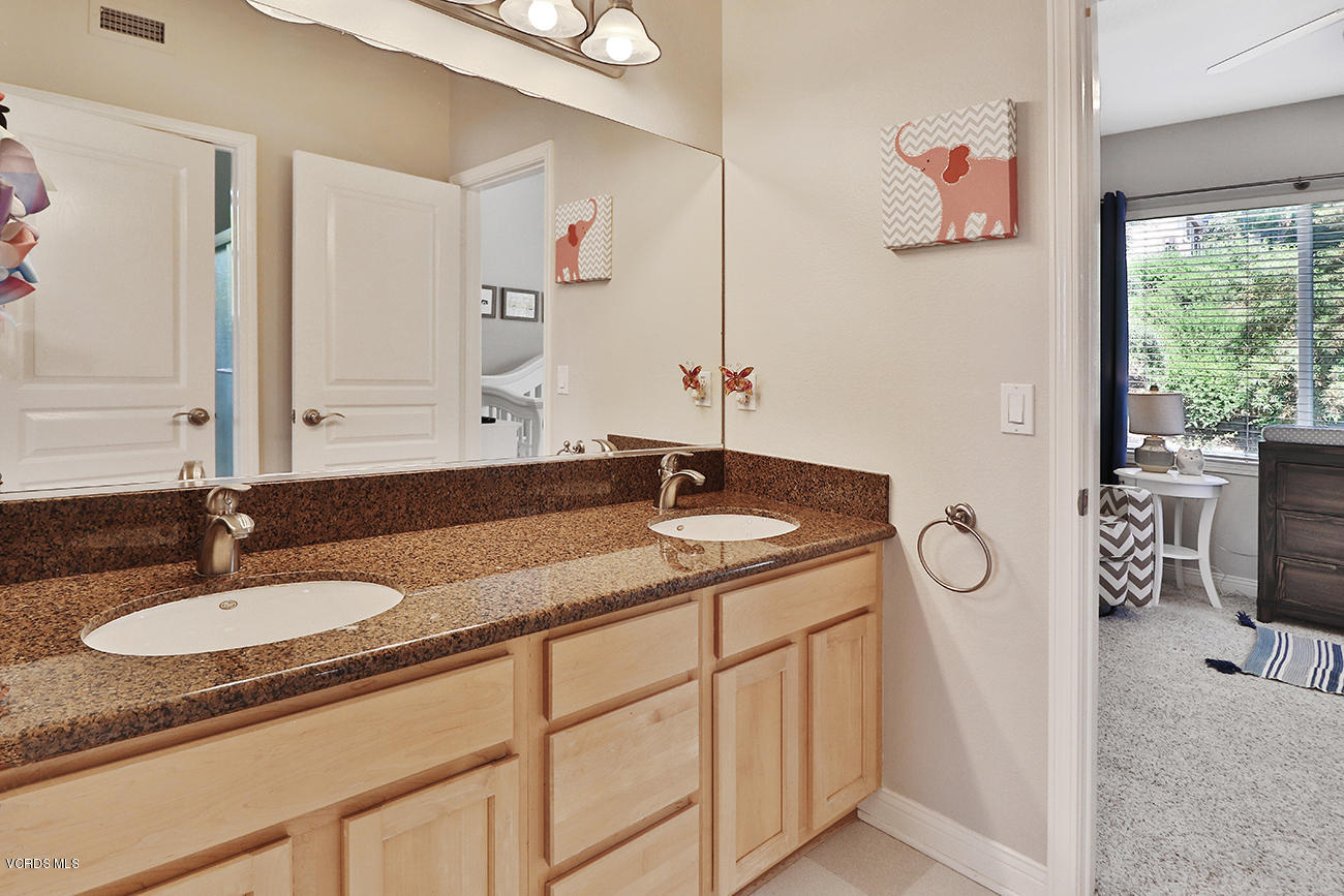 143 Brooks Road Simi Valley, CA 93065 - Photo 23 of 42 a bathroom with a granite countertop sink and a mirror