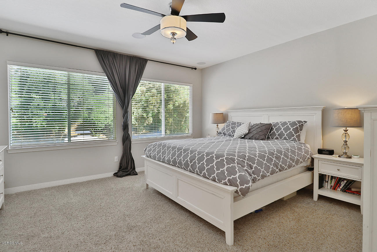 143 Brooks Road Simi Valley, CA 93065 - Photo 26 of 42 a bedroom with a bed lamp and window