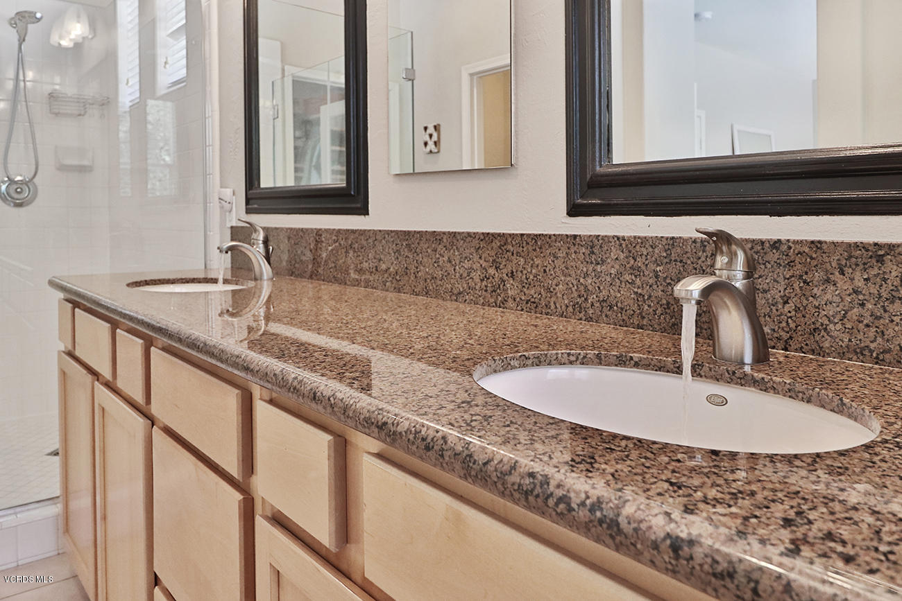143 Brooks Road Simi Valley, CA 93065 - Photo 29 of 42 a bathroom with a granite countertop sink and a mirror
